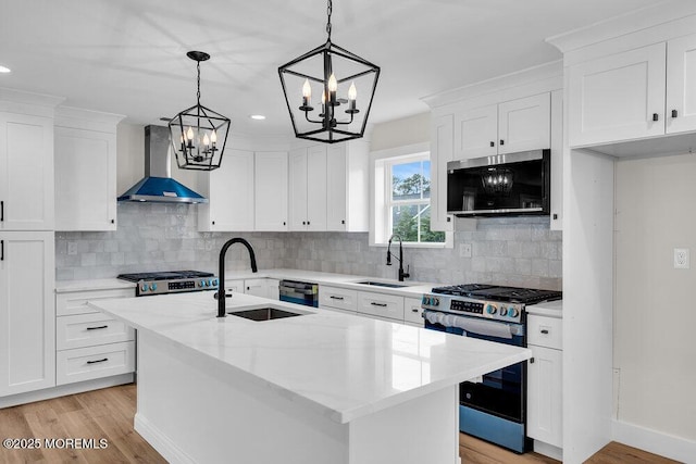 629 Monmouth Ave, Toms River, NJ 08757 - kitchen featuring wall chimney range hood, stainless steel appliances, a chandelier, light wood-style floors, and recessed lighting