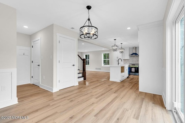 629 Monmouth Ave, Toms River, NJ 08757 - unfurnished living room featuring a chandelier, stairway, light wood-type flooring, and recessed lighting