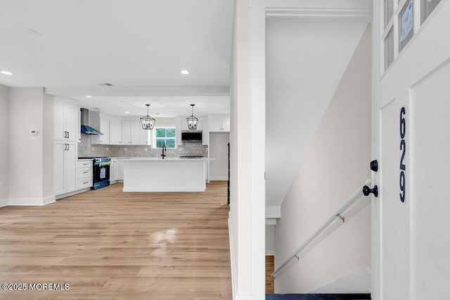 629 Monmouth Ave, Toms River, NJ 08757 - kitchen with wall chimney exhaust hood, appliances with stainless steel finishes, white cabinets, tasteful backsplash, and recessed lighting