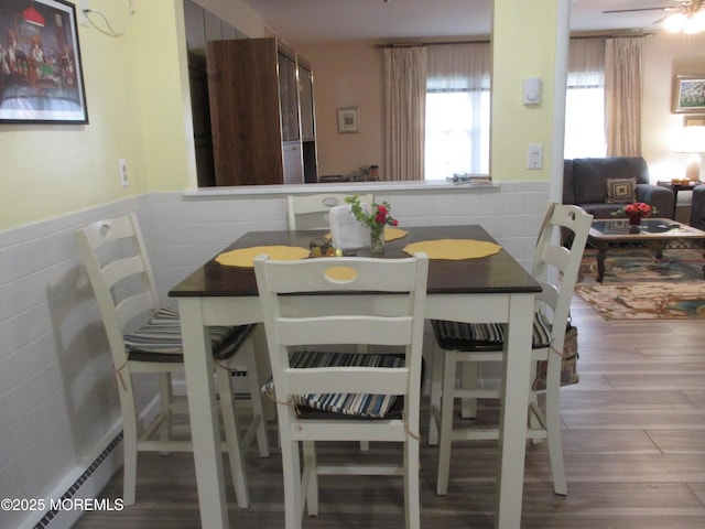 496A Thornbury Ct, Lakewood, NJ 08701 - dining room with tile walls, wood finished floors, wainscoting, and baseboard heating