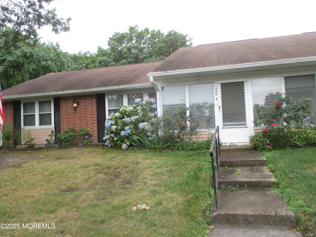 496A Thornbury Ct, Lakewood, NJ 08701 - view of front of house with a front yard, a shingled roof, and brick siding