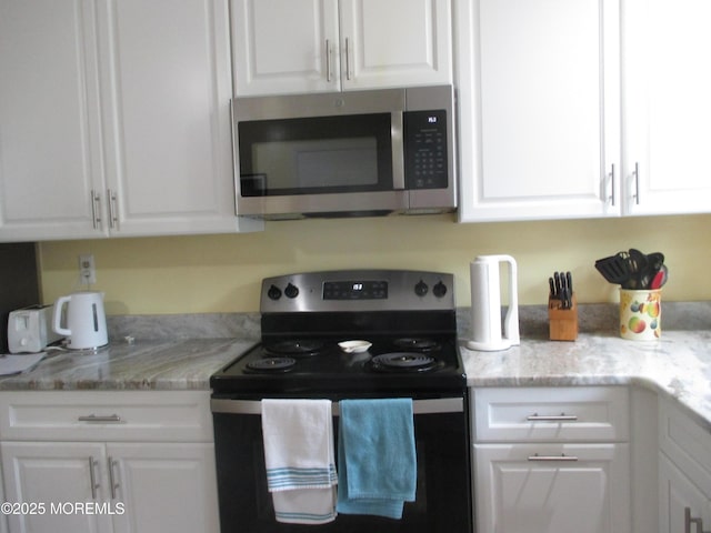 496A Thornbury Ct, Lakewood, NJ 08701 - kitchen featuring appliances with stainless steel finishes, white cabinetry, and light stone counters