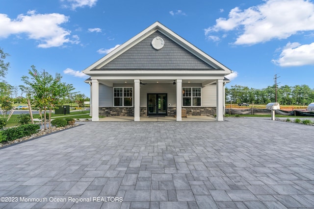 750 Lighthouse Dr Unit 1306, Barnegat, NJ 08005 - back of house featuring french doors, stone siding, and covered porch