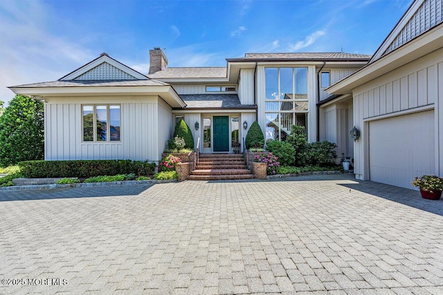 787 Princeton Ave, Brick, NJ 08724 - view of front of house featuring decorative driveway, a chimney, board and batten siding, and a garage