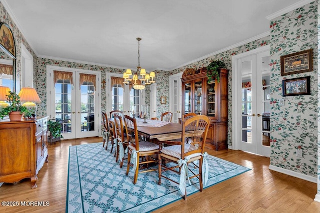 787 Princeton Ave, Brick, NJ 08724 - dining area featuring french doors, wallpapered walls, a chandelier, light wood finished floors, and crown molding