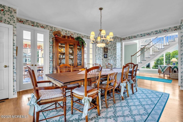 787 Princeton Ave, Brick, NJ 08724 - dining area featuring wallpapered walls, a chandelier, stairs, plenty of natural light, and wood finished floors