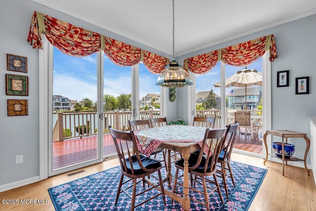 787 Princeton Ave, Brick, NJ 08724 - dining space with wallpapered walls, ornamental molding, and wood finished floors