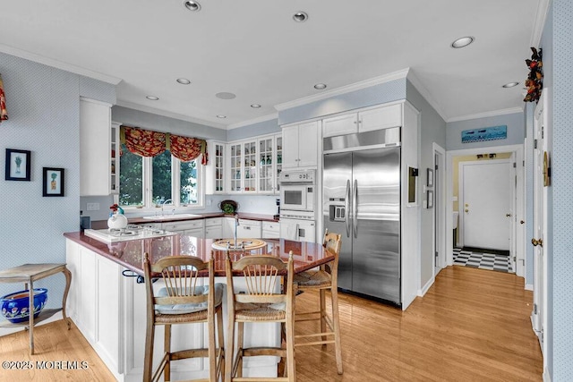 787 Princeton Ave, Brick, NJ 08724 - kitchen with stainless steel built in refrigerator, ornamental molding, light wood-type flooring, a peninsula, and glass insert cabinets