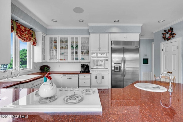 787 Princeton Ave, Brick, NJ 08724 - kitchen with white appliances, ornamental molding, dark countertops, glass insert cabinets, and white cabinets