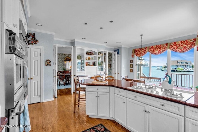 787 Princeton Ave, Brick, NJ 08724 - kitchen with white gas stovetop, crown molding, white cabinets, a breakfast bar, and light wood-style floors