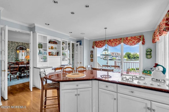 787 Princeton Ave, Brick, NJ 08724 - kitchen with a breakfast bar, light wood finished floors, white cabinets, hanging light fixtures, and open shelves