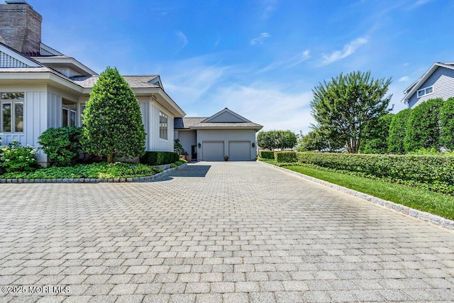 787 Princeton Ave, Brick, NJ 08724 - view of front facade with board and batten siding, a garage, and decorative driveway