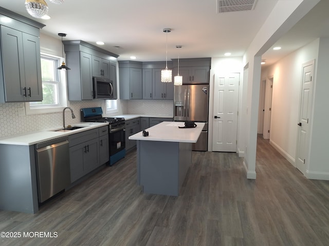 414 Oak Tree Rd, Freehold, NJ 07728 - kitchen featuring appliances with stainless steel finishes, gray cabinetry, dark wood-style floors, light countertops, and tasteful backsplash