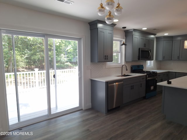 414 Oak Tree Rd, Freehold, NJ 07728 - kitchen featuring stainless steel appliances, gray cabinetry, dark wood-type flooring, light countertops, and decorative backsplash