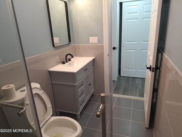 414 Oak Tree Rd, Freehold, NJ 07728 - bathroom with vanity, tile walls, wainscoting, and tile patterned flooring
