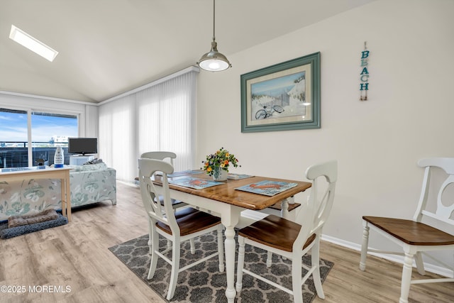 2108 SE Central Ave Unit 10, South Seaside Park, NJ 08752 - dining area featuring vaulted ceiling, wood finished floors, and a skylight