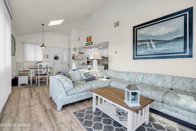 2108 SE Central Ave Unit 10, South Seaside Park, NJ 08752 - living room with light wood-type flooring, a skylight, and vaulted ceiling