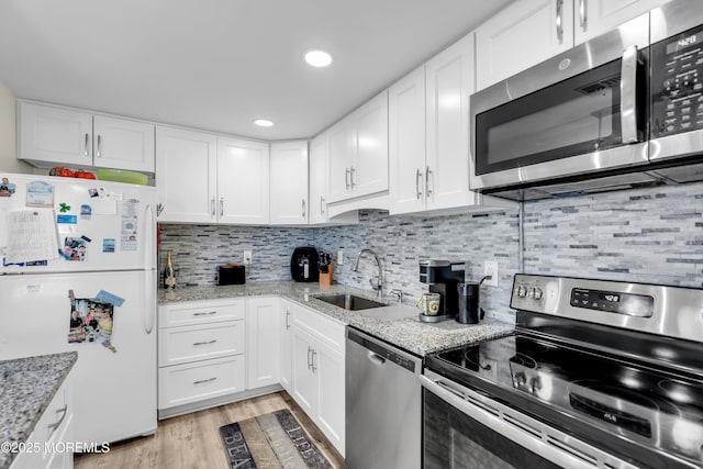 2108 SE Central Ave Unit 10, South Seaside Park, NJ 08752 - kitchen with appliances with stainless steel finishes, white cabinetry, and recessed lighting