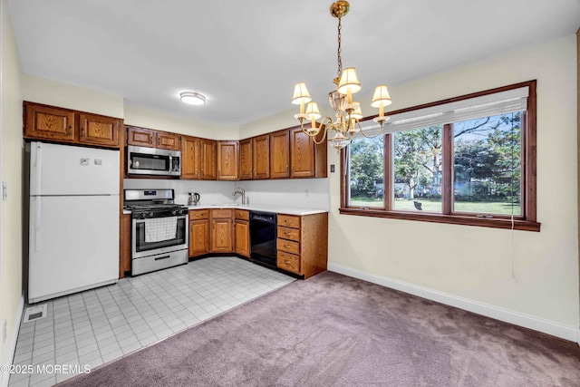 3 Colorado Dr, Hazlet, NJ 07730 - kitchen with stainless steel appliances, a chandelier, light countertops, brown cabinets, and light colored carpet