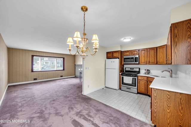 3 Colorado Dr, Hazlet, NJ 07730 - kitchen with appliances with stainless steel finishes, light carpet, brown cabinetry, a chandelier, and light countertops