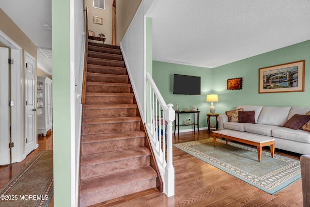 1914 Oak Dale Rd, Toms River, NJ 08753 - living area featuring wood finished floors, stairs, and a textured ceiling