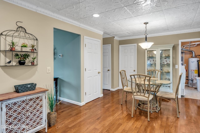 1914 Oak Dale Rd, Toms River, NJ 08753 - dining room with gas water heater, crown molding, and wood finished floors