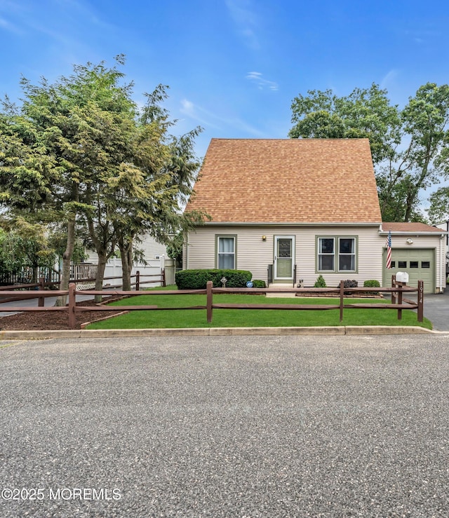 1914 Oak Dale Rd, Toms River, NJ 08753 - cape cod house featuring an attached garage, a fenced front yard, and roof with shingles