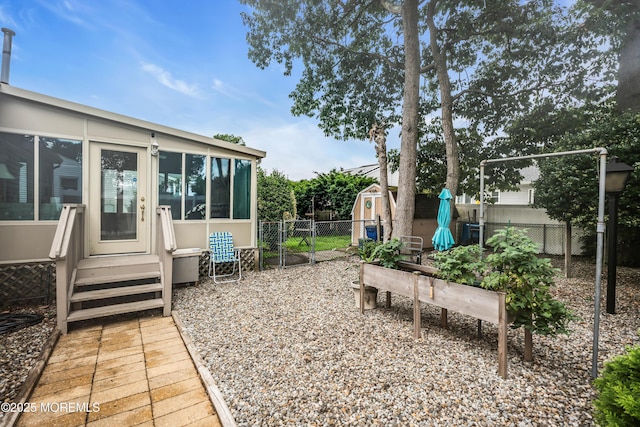 1914 Oak Dale Rd, Toms River, NJ 08753 - fenced backyard with a storage unit, a sunroom, and a gate