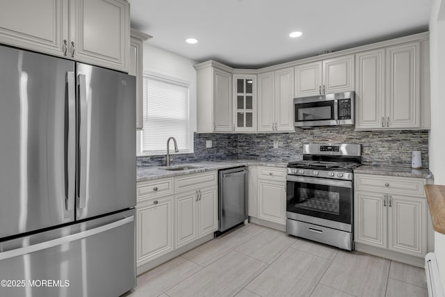 925 Edgebrook Dr N, Toms River, NJ 08757 - kitchen with stainless steel appliances, tasteful backsplash, a baseboard heating unit, light stone countertops, and glass insert cabinets