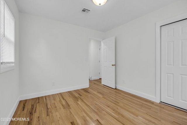 925 Edgebrook Dr N, Toms River, NJ 08757 - unfurnished bedroom featuring multiple windows and light wood-style flooring