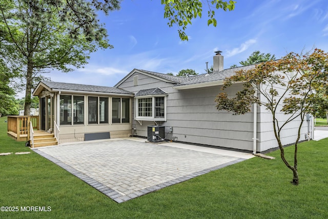 925 Edgebrook Dr N, Toms River, NJ 08757 - rear view of house featuring a sunroom, a chimney, a yard, a patio area, and a shingled roof