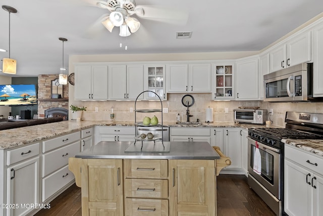 1587 Fort St, Brick, NJ 08724 - kitchen featuring appliances with stainless steel finishes, a ceiling fan, dark wood-style flooring, and glass insert cabinets