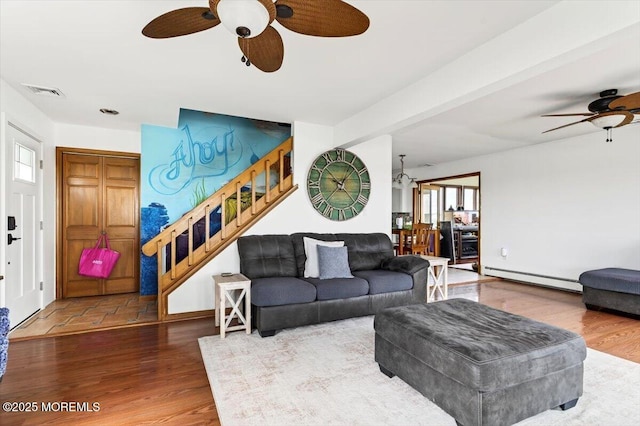 322 Dock Rd, West Creek, NJ 08092 - living room featuring a ceiling fan, baseboard heating, wood finished floors, and stairway