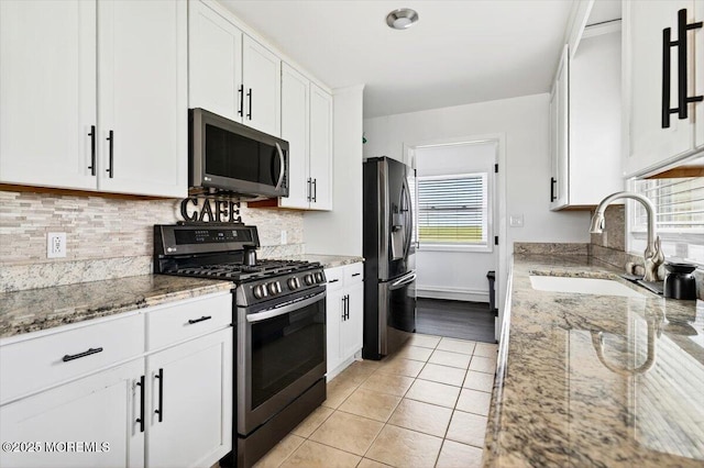 322 Dock Rd, West Creek, NJ 08092 - kitchen featuring appliances with stainless steel finishes, white cabinetry, decorative backsplash, and light tile patterned floors