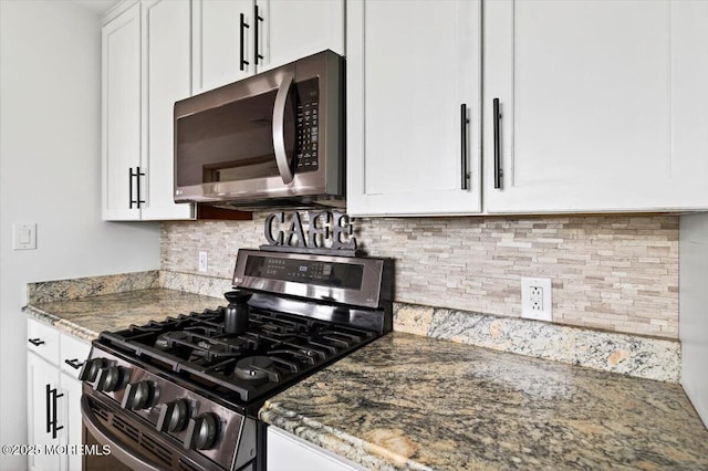 322 Dock Rd, West Creek, NJ 08092 - kitchen featuring stainless steel appliances, white cabinetry, stone counters, and backsplash