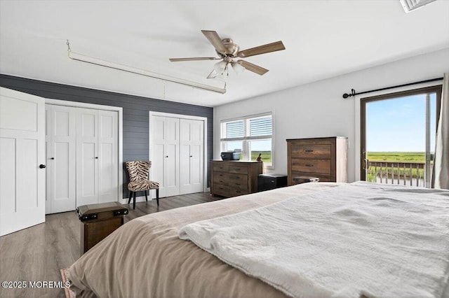 322 Dock Rd, West Creek, NJ 08092 - bedroom with wood finished floors, two closets, access to exterior, and ceiling fan
