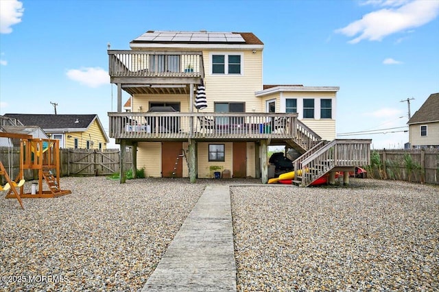 322 Dock Rd, West Creek, NJ 08092 - rear view of house with stairs, a fenced backyard, a deck, a gate, and a playground