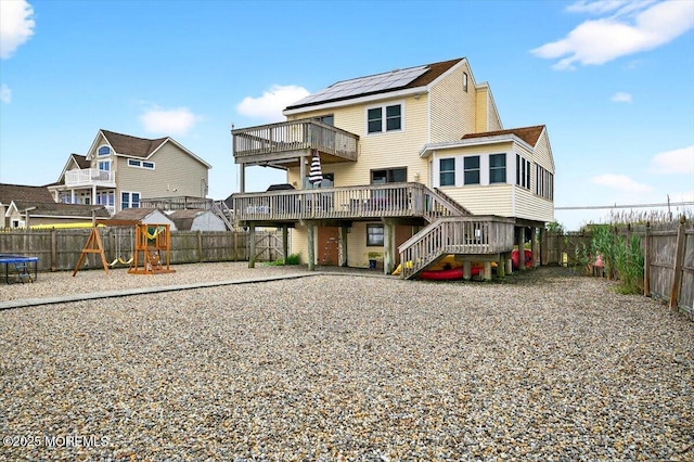 322 Dock Rd, West Creek, NJ 08092 - rear view of house featuring a wooden deck, a fenced backyard, stairway, and a playground