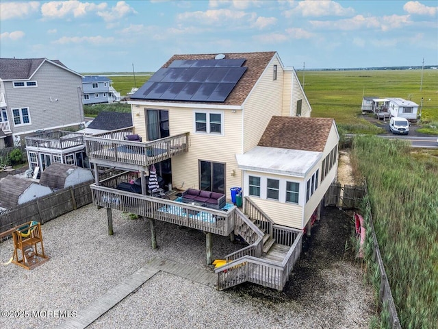 322 Dock Rd, West Creek, NJ 08092 - rear view of property with stairs, a deck, roof mounted solar panels, roof with shingles, and a fenced backyard