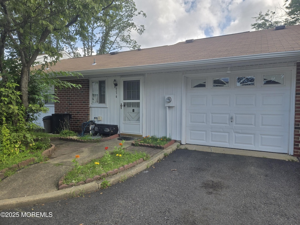 833B Inverness Ct, Lakewood, NJ 08701 - view of front of house with a garage, driveway, a shingled roof, and board and batten siding