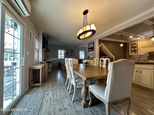 224 5th St Unit A, Beach Haven, NJ 08008 - dining area featuring a wall unit AC, light wood-type flooring, ornamental molding, and a chandelier