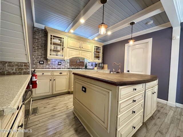 224 5th St Unit A, Beach Haven, NJ 08008 - kitchen featuring cream cabinetry, wooden counters, light wood finished floors, beam ceiling, and backsplash