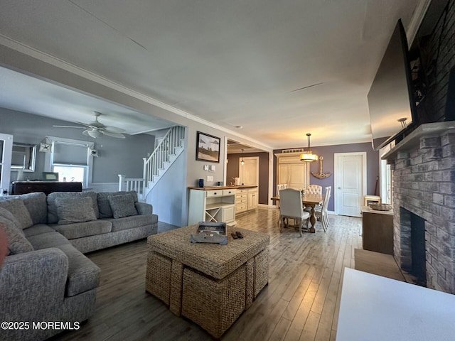 224 5th St Unit A, Beach Haven, NJ 08008 - living area featuring hardwood / wood-style floors, a fireplace, crown molding, stairs, and ceiling fan