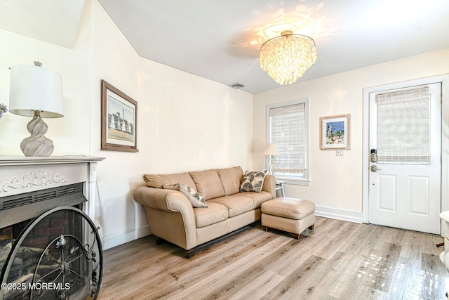 132 Heck Ave, Ocean Grove, NJ 07756 - living area with light wood-style floors, a chandelier, and a fireplace