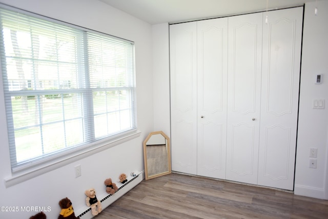 8B Cambridge Cir, Manchester, NJ 08759 - unfurnished bedroom featuring a baseboard heating unit, light wood-type flooring, and a closet