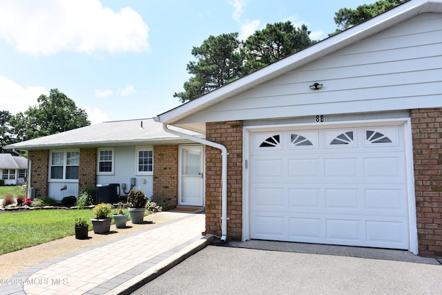 8B Cambridge Cir, Manchester, NJ 08759 - ranch-style home featuring a garage, brick siding, driveway, and a front yard