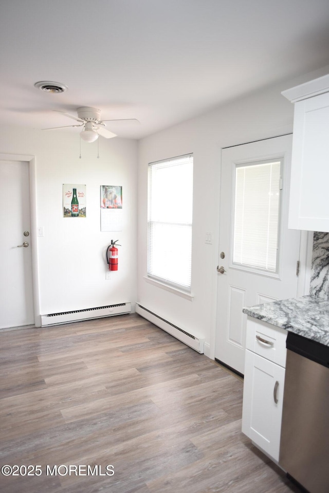 8B Cambridge Cir, Manchester, NJ 08759 - unfurnished dining area with a baseboard heating unit, a ceiling fan, baseboard heating, and light wood-style flooring