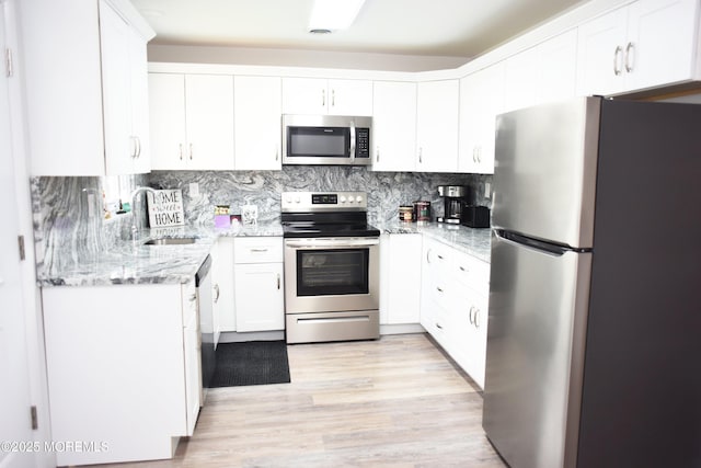 8B Cambridge Cir, Manchester, NJ 08759 - kitchen with appliances with stainless steel finishes, light stone countertops, backsplash, and white cabinets