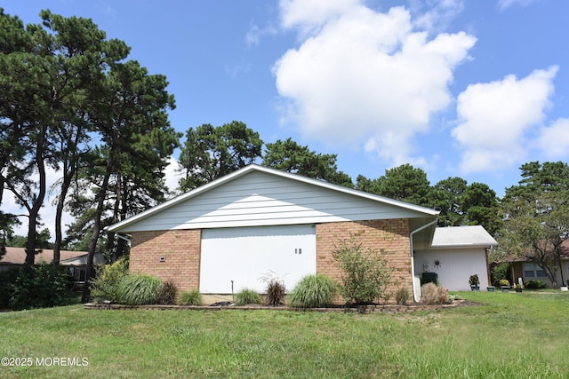 8B Cambridge Cir, Manchester, NJ 08759 - view of side of property with brick siding, a garage, and a yard