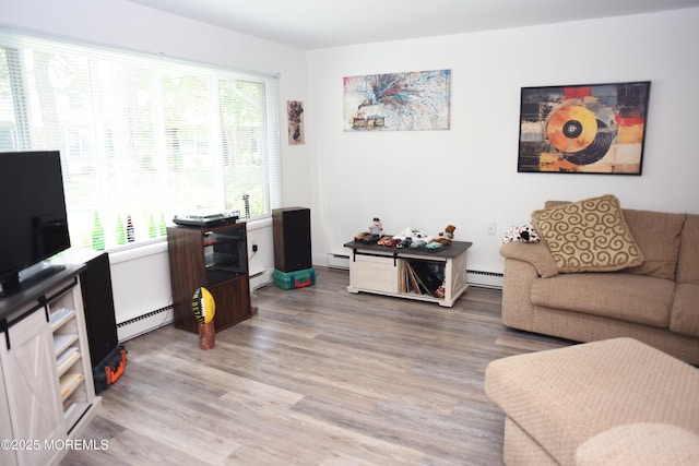 8B Cambridge Cir, Manchester, NJ 08759 - living room with a baseboard radiator and light wood-style floors